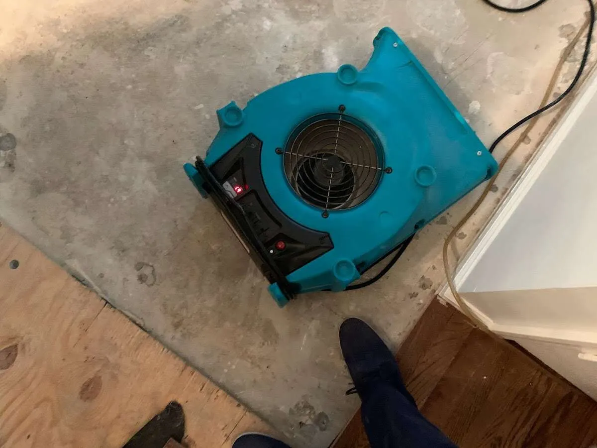 Air mover drying subfloor during Commercial Water Damage Restoration in Irondequoit